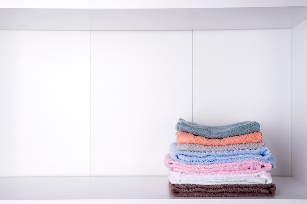 Stack of bath towels on light background