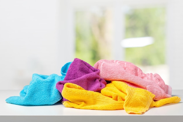 Stack of bath towels on white desk closeup