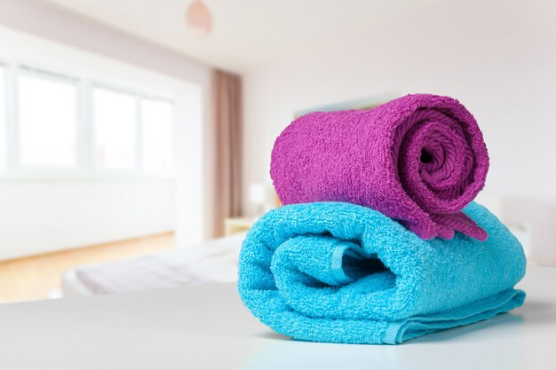 Stack of bath towels on white desk closeup