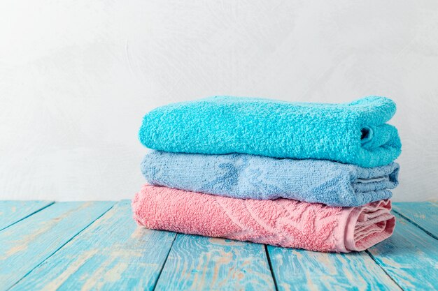 Stack of bath towels on wooden table