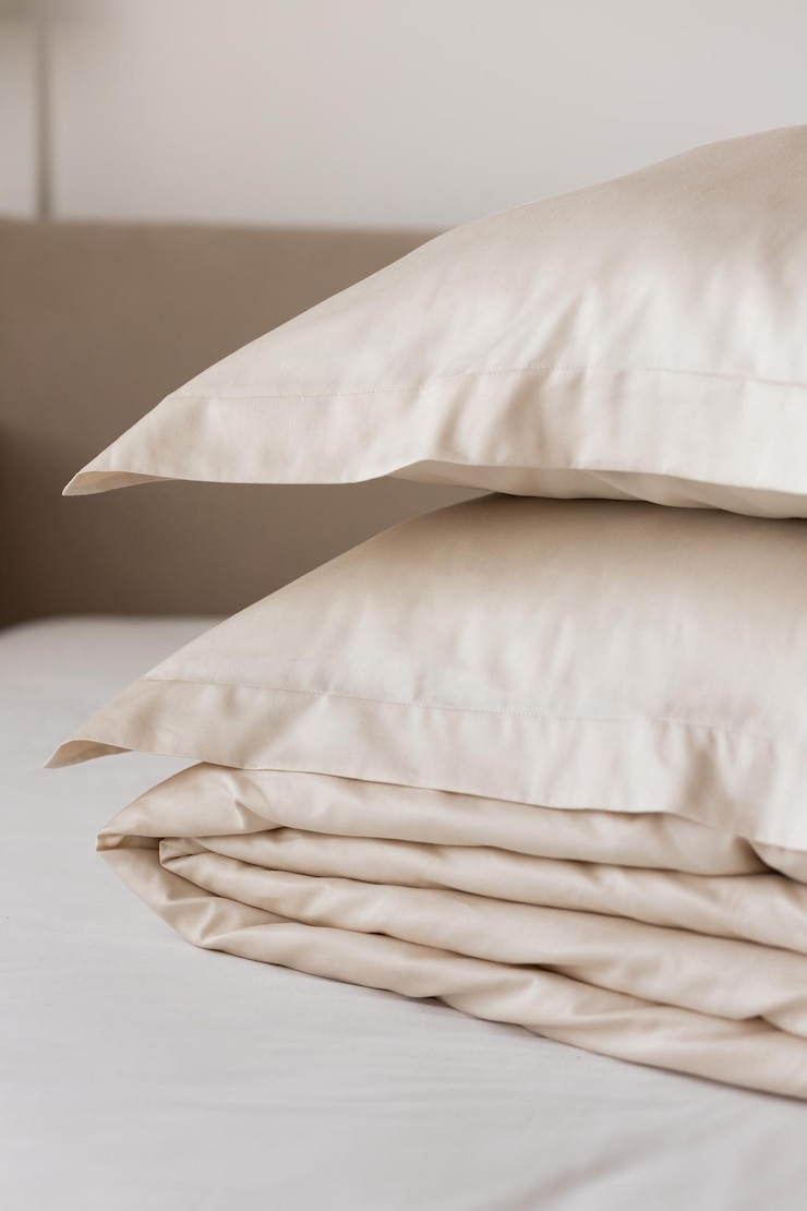 Photo stack of beige satin bed linen satin lyocell silk duvet cover and pillowcases home textiles