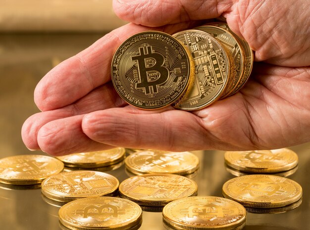 Stack of bitcoins with gold background