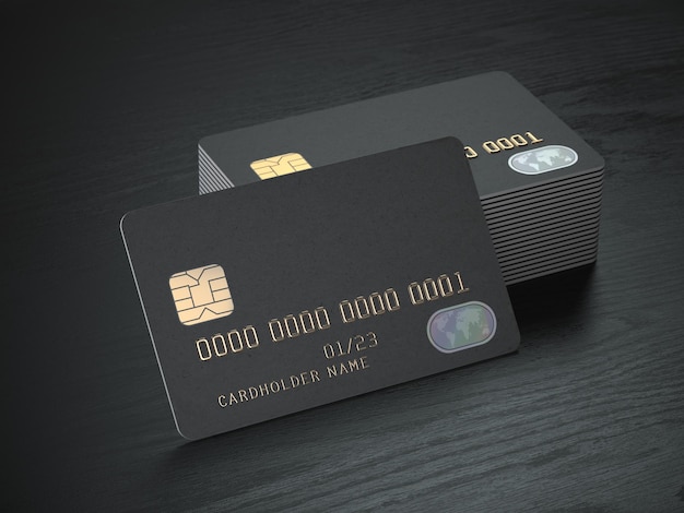 Stack of black blank credit cards mockup on black wood table background