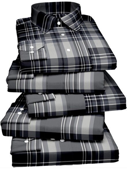 A stack of black and grey plaid shirts with the word " x " on the front.