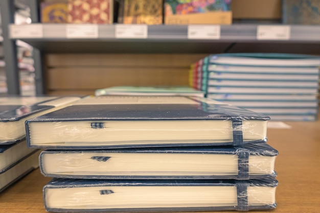 Stack of black notebooks on display