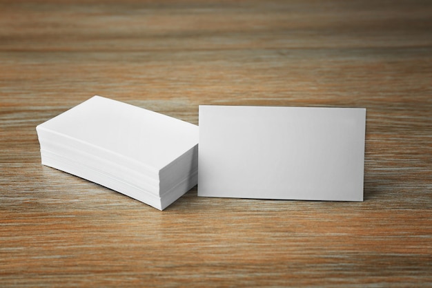 Stack of blank business cards on wooden background