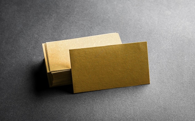 Stack of blank golden business card on grey background. Blank name card.