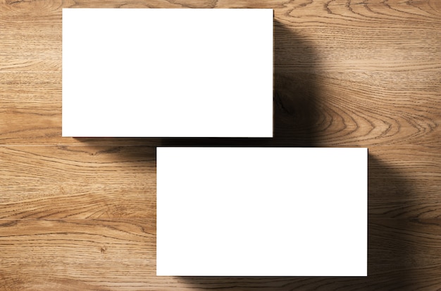 Stack of blank name cards on wooden background