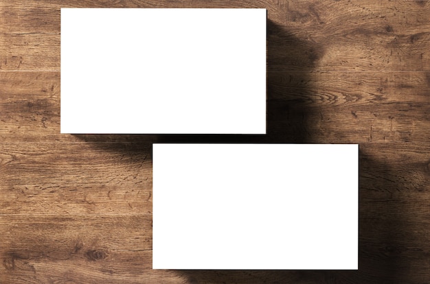 Photo stack of blank name cards on wooden background