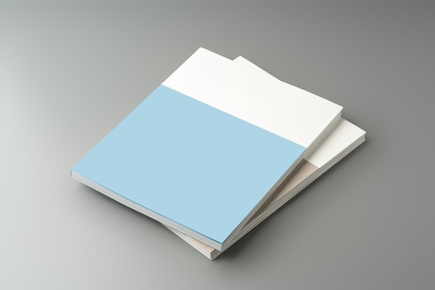 a stack of blank notebooks arranged neatly on a simple grey background