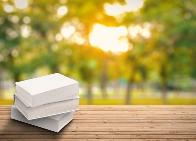 Stack of blank notebooks on wooden table