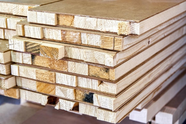 Stack of block boards made of wooden planks and MDF in carpentry warehouse