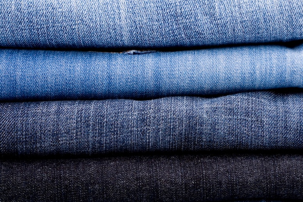 Stack of blue jeans closeup