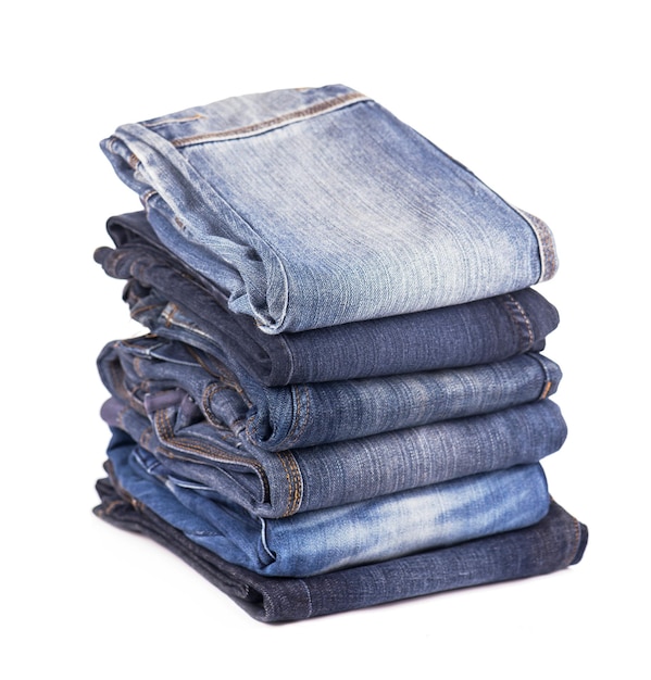 Photo stack of blue jeans on a white background