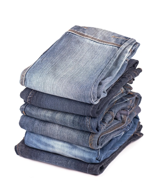 Stack of blue jeans on a white background