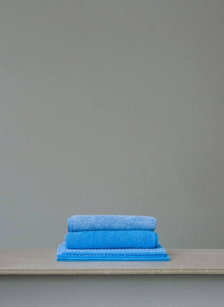 Photo stack of blue microfiber cloths on grey