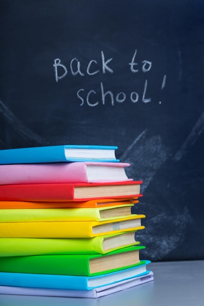 Photo stack of books against the background of the teachers' board