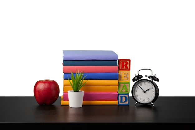 Stack of books and alarm clock time to read concept