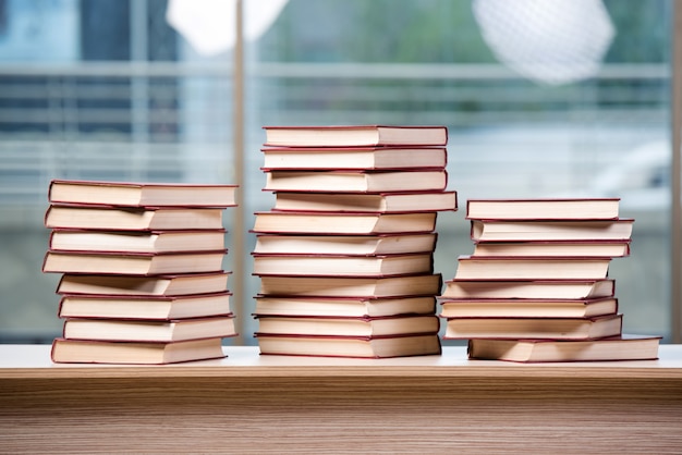 Stack of books arranged the office desk