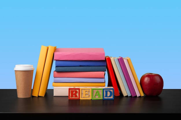 Stack of books on black wooden table