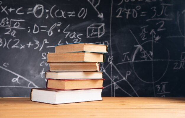 Stack of books on the blackboard