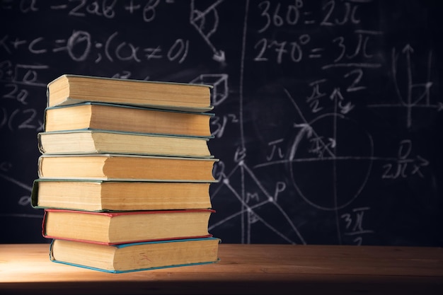 Stack of books in chalkboard background