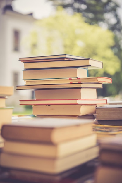 Stack of books at a charity book flea market text space