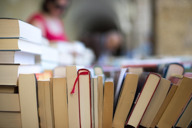 Stack of books at a charity book flea market text space