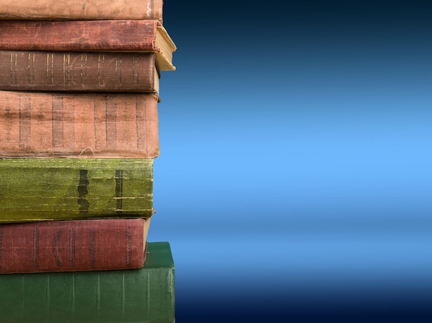 Stack of books on the color gradient background space for text