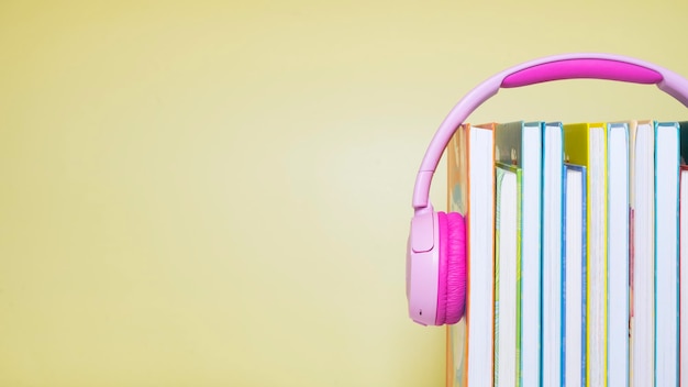 Stack of books and headphones on the table