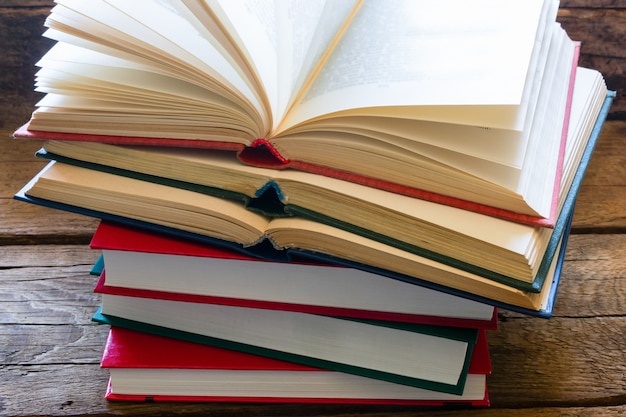 Stack of books for learning on a wooden background