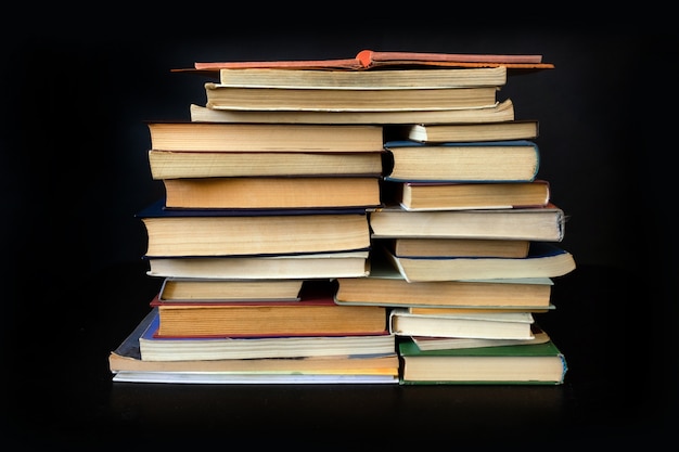 Stack books old black background notebook library