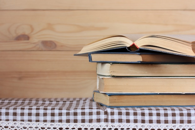 Stack of books and one open book on the table. Empty space for Your text. Library, reading.