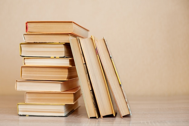 A stack of books stand on the table