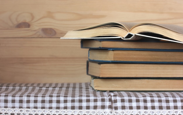 Stack of books on the table. Library, education, reading. Open hardcover book