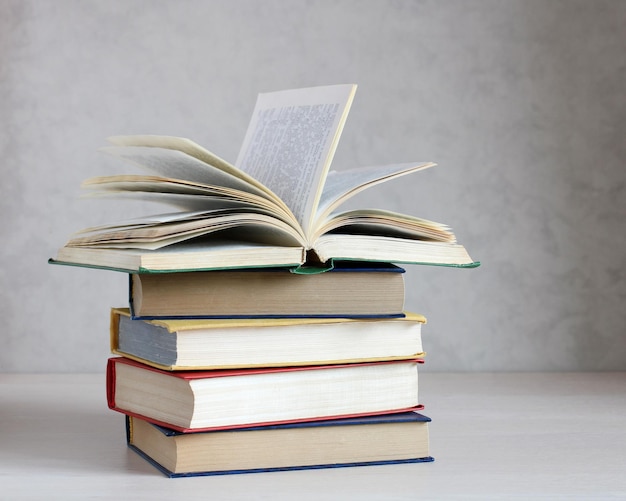 Stack of books on the table an open book or textbook education literature