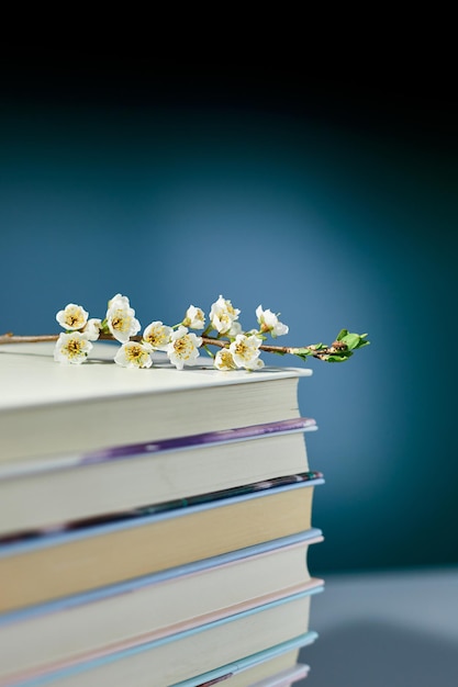 Stack of books with branch flowers World book day