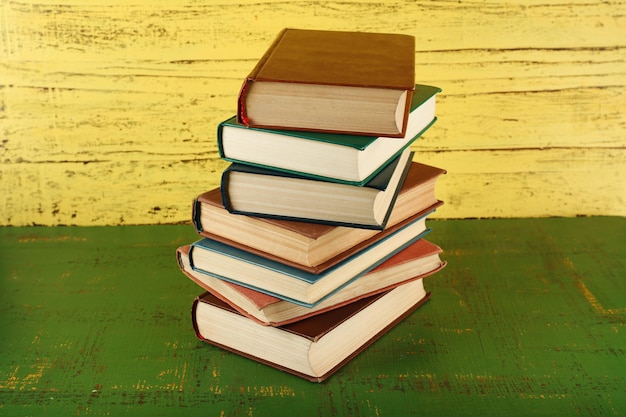 Stack of books on wooden background