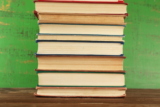 Stack of books on wooden background