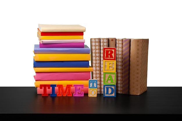 Photo stack of books on wooden table against white background