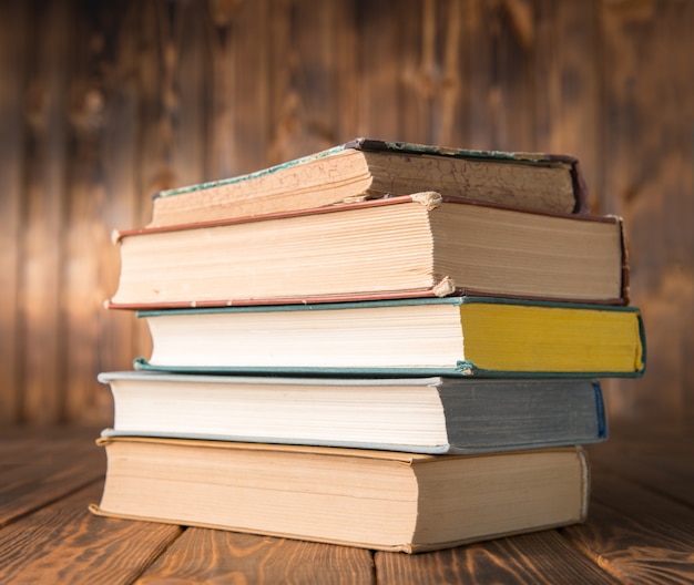 Stack of books on a wooden table