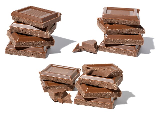 A stack of broken milk chocolate on a white isolated background square pieces