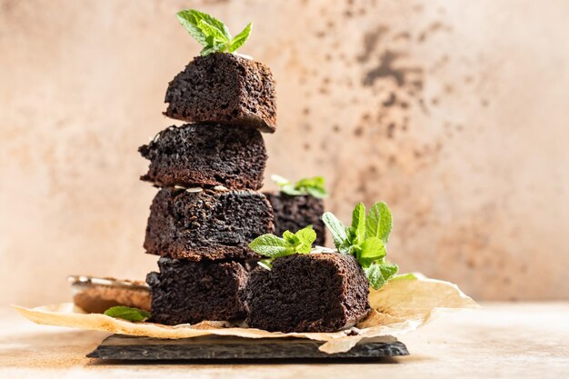 Stack of brownies made of dark chocolate Tasty fudge and chewy dessert with pieces of chocolate