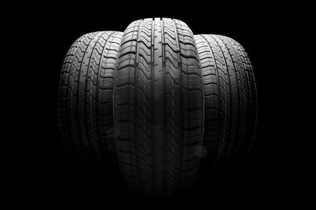 stack of car tires on black background