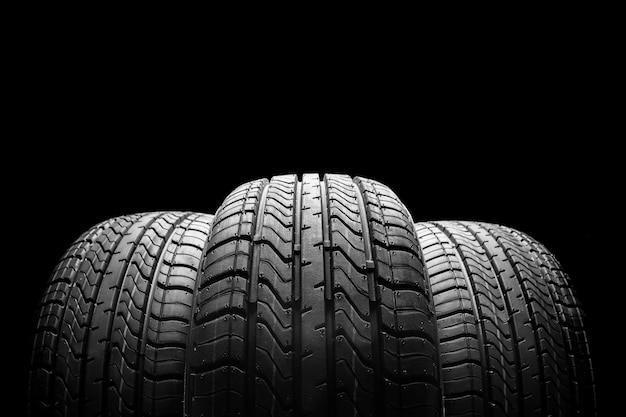 stack of car tires on black background