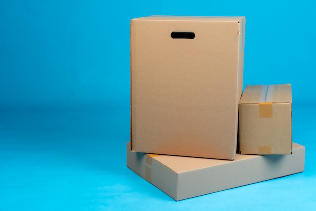 Stack of cardboard boxes on blue