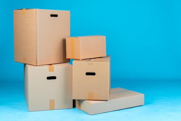 Stack of cardboard boxes on blue