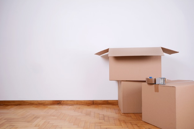 Stack of cardboard boxes in the empty room