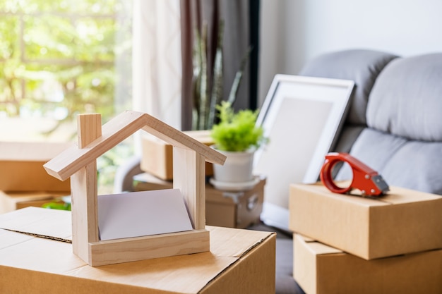 Stack of cardboard boxes in living room at new house on moving day