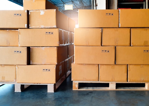 Stack of cardboard boxes on wooden pallet. Cargo export, shipment, shipping warehouse.